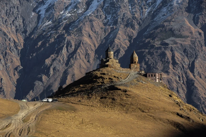 a car is parked at the top of a mountain, by Muggur, dau-al-set, churches, high res, two towers, ancient”