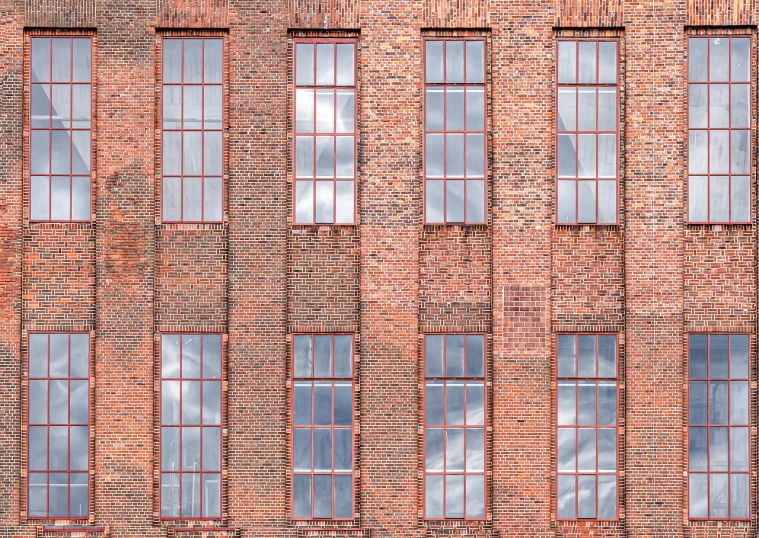 a red fire hydrant sitting in front of a tall brick building, a stock photo, inspired by Matthias Jung, modernism, steel window mullions, flat texture, tall factory, in a row