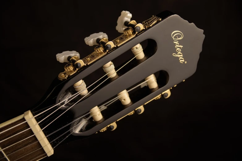 a close up of the headstock of a guitar, inspired by Charles Gleyre, arabesque, glass and metal : : peugot onyx, high detail portrait photo, nostalgic atmosphere, angle view