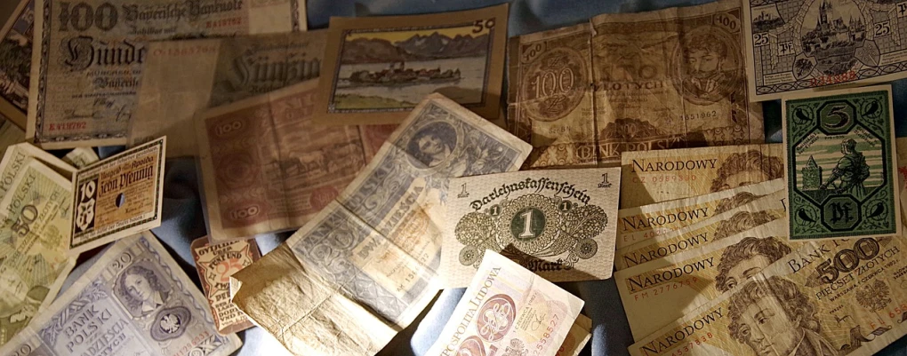 a pile of old money sitting on top of a table, by Hans Werner Schmidt, pixabay, set in ww2 germany, banner, museum collection, stunning screenshot