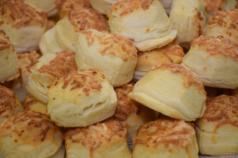 a pile of pastries sitting on top of a table, by Judy Cassab, melted cheddar, close-up product photo, local close up, ready to eat