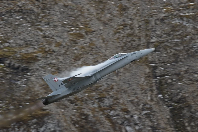 a fighter jet is flying through the air, by Dietmar Damerau, flickr, in the swiss alps, white fur, november, - - ar 9 : 1 6