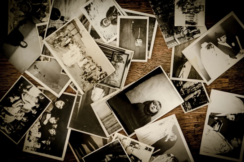 a bunch of old black and white photos on a table, a black and white photo, photograph”, photograph ”, on a wooden table, world war 2 portrait photo