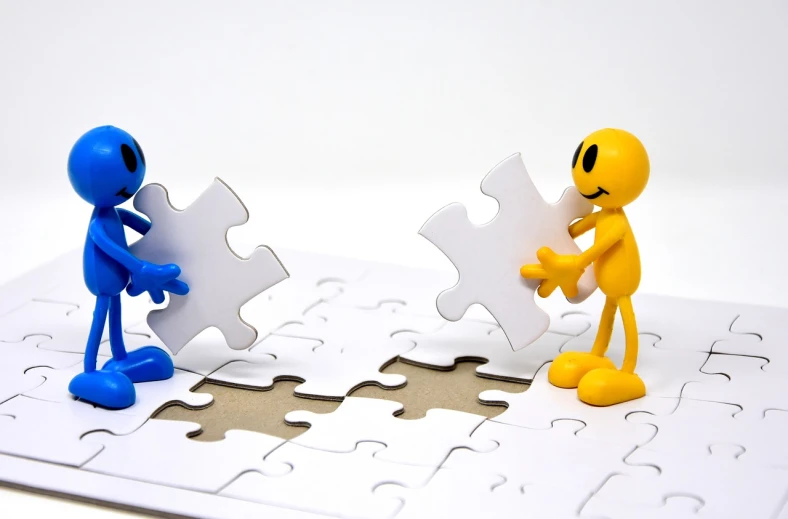 a couple of figurines standing on top of a puzzle piece, a jigsaw puzzle, by Eugeniusz Zak, pixabay contest winner, in blue and yellow clothes, medium shot of two characters, reaching out to each other, programming