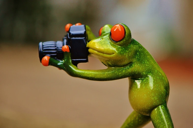 a figurine of a frog holding a camera, by Robert Brackman, pexels, in an action pose, !!!!!!!!!!!!!!!!!!!!!!!!!, peepo the frog!!!, photo-shopped