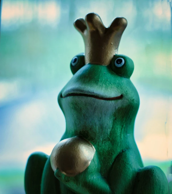 a statue of a frog with a crown on its head, a picture, pexels, sitting on a window sill, claymation style, flirting, “portrait of a cartoon animal