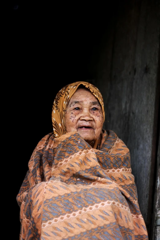 an old woman wrapped up in a blanket, a portrait, sumatraism, high quality image, portrait mode photo, portrait of a slightly rusty, while smiling for a photograph