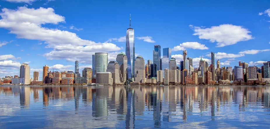 a large body of water with a city in the background, a picture, by Bernardino Mei, shutterstock, world trade center twin towers, on a bright day, high reflections, 1128x191 resolution