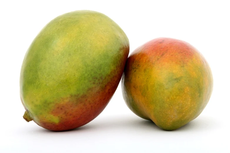 two mangoes sitting next to each other on a white surface, figuration libre, file photo, rasta, detailed zoom photo, slightly muscular