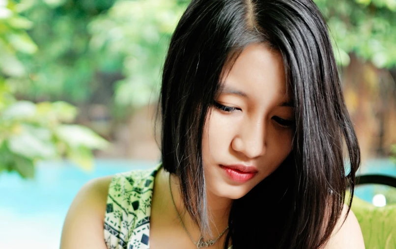 a close up of a woman looking at a cell phone, a picture, inspired by Xia Shuwen, realism, beautiful asian girl, shy looking down, portait photo profile picture, wallpaper - 1 0 2 4