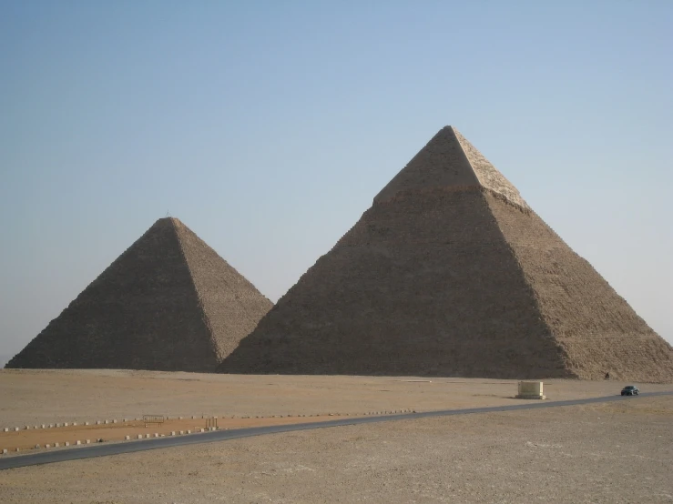 a group of three pyramids in the desert, author unknown, adult pair of twins, view from the side”, 2 0 1 0 photo