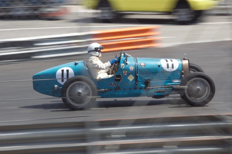 a man driving a blue race car on a track, inspired by Harry Haenigsen, flickr, jazz age, ebay photo, on flickr in 2007, monaco