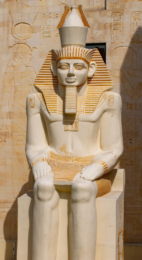 a statue of an egyptian man sitting on a bench, egyptian art, inspired by Nicomachus of Thebes, shutterstock, fine art, albino, high res photo, symmetrical front view, full length photo