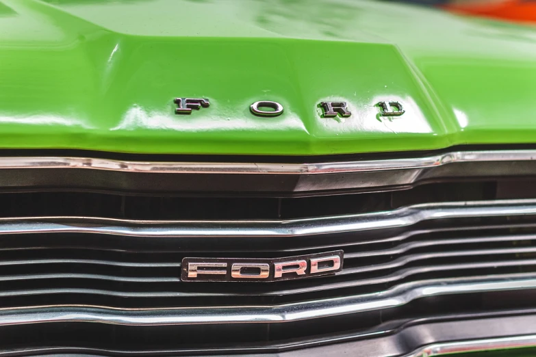 a close up of the front of a green car, a stock photo, by Jakob Gauermann, pexels, pop art, ford f-150 raptor, retro 1 9 7 0 s kodachrome, sao paulo, focus stacking