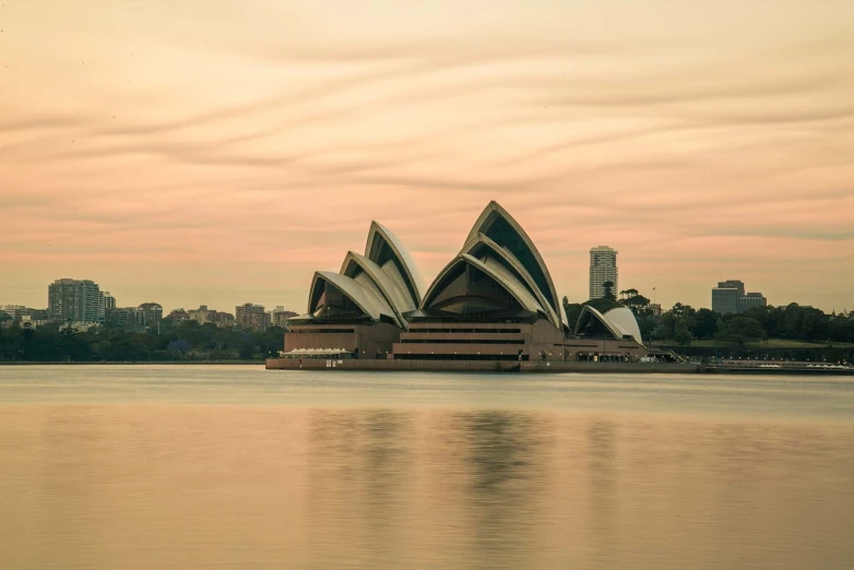 a large building sitting on top of a body of water, inspired by Sydney Carline, pexels contest winner, australian tonalism, golden hour photo, tony roberts, geodesic building, a dream