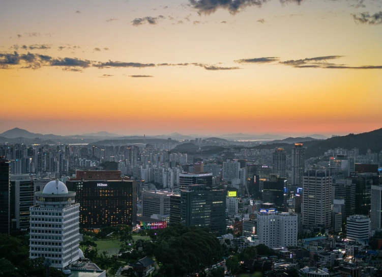 a view of a city from the top of a hill, by Simon Gaon, unsplash contest winner, sangsoo jeong, summer sunset, 180mm f/1.8, -640