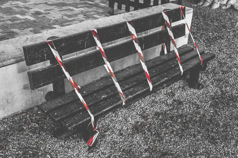 a black and white photo of a park bench, by Richard Carline, police tape, red and black colour scheme, maintenance photo, construction