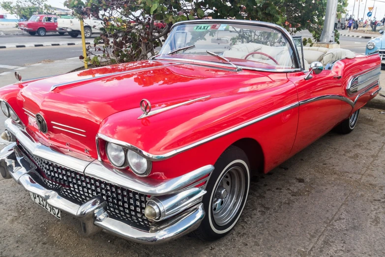 a red classic car parked on the side of the road, a pastel, by Joe Bowler, flickr, jamaica, convertible, elaborate detail, shark