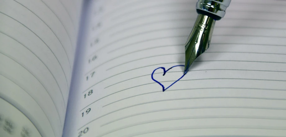 a pen writing on a notebook with a heart drawn on it, a picture, happening, date, vertical wallpaper, really long, blue