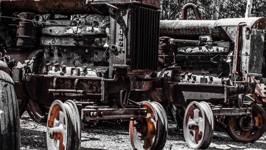 a black and white photo of an old tractor, by Richard Carline, precisionism, posterized color, rusty metal towers, full width, covered with tar. dslr