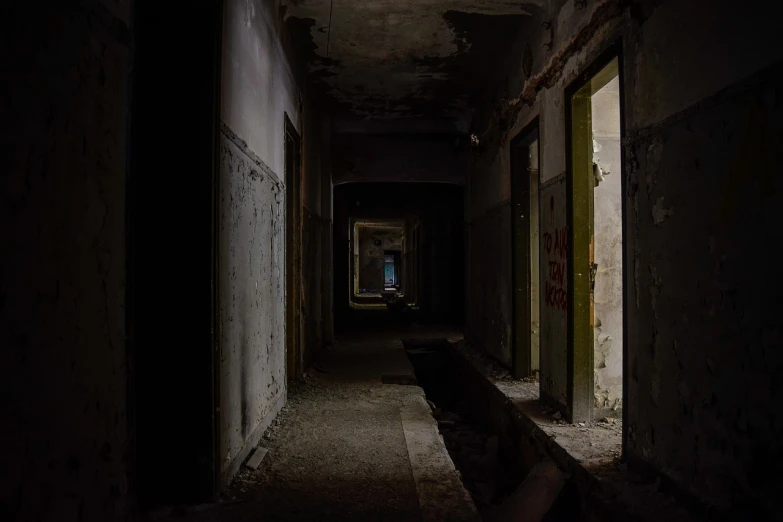 a dark hallway with a bench in the middle of it, by Stefan Gierowski, rundown buildings, the photo shows a large, pupil