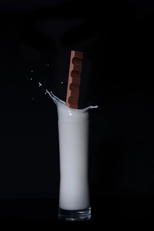 a chocolate bar falling into a glass of milk, by Yasushi Sugiyama, unsplash, conceptual art, liquid sculpture, trident, close establishing shot, 1790