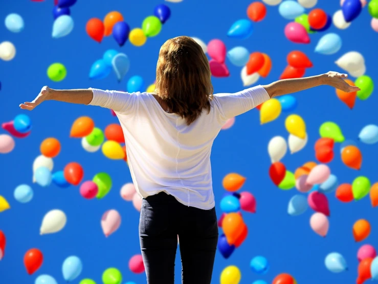 a woman standing in front of a bunch of balloons, pexels, his arms spread. ready to fly, 😃😀😄☺🙃😉😗, avatar image, freedom from cptsd