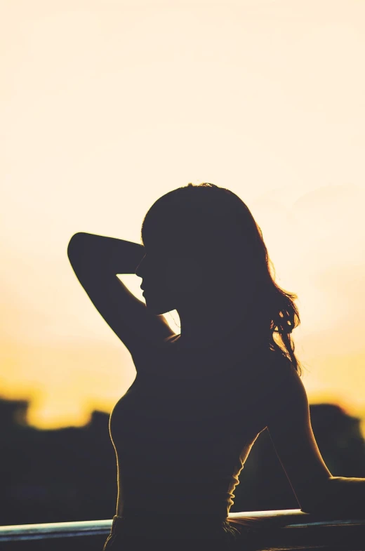 a silhouette of a woman standing in front of a sunset, a picture, figuration libre, beautiful sexy woman photo, focused on her neck, half body photo