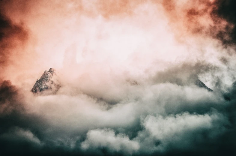 a plane flying through a cloudy sky with a mountain in the background, a picture, by Matthias Weischer, romanticism, colored fog, ceremonial clouds, alessio albi, no words 4 k