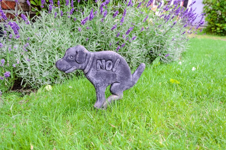 a statue of a dog with the word no on it, sitting in the garden, no aditional legs!, button nose, walking down