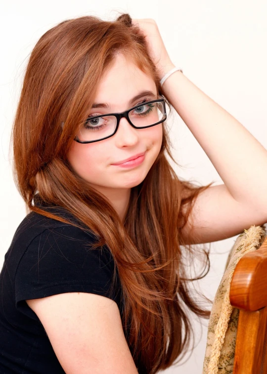 a woman with glasses posing for a picture, a picture, inspired by Lydia Field Emmet, shutterstock, cute young redhead girl, musician, square rimmed glasses, teenage