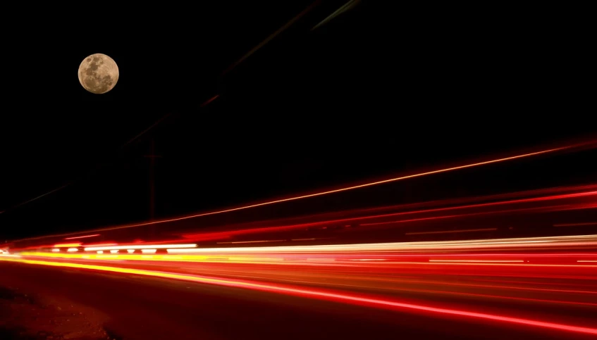 a street at night with a full moon in the background, a picture, pexels, red spike aura in motion, traffic with light trails, 4k vertical wallpaper, dark orange black white red