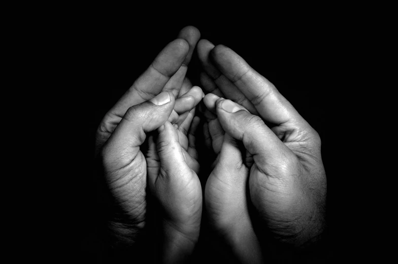 a black and white photo of a person's hands, by Matija Jama, fine art, prayer hands, greg hildebrant, family, high detailed photo