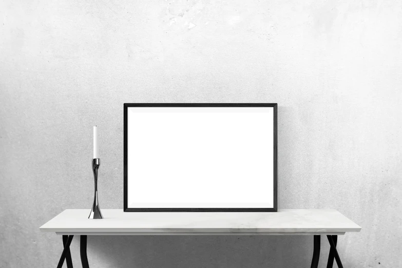 a picture frame sitting on top of a table next to a candle, a minimalist painting, minimalism, monochrome background, product introduction photo