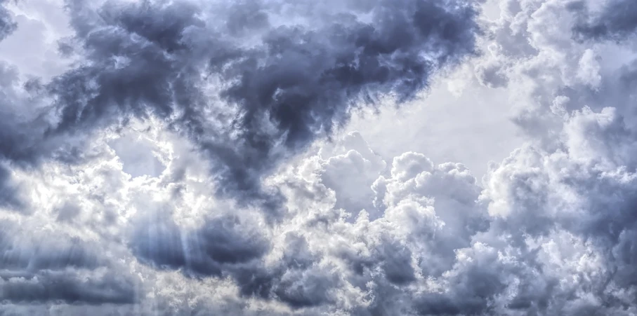 there is a plane that is flying in the sky, by Jan Rustem, romanticism, dark mammatus cloud, shades of blue and grey, sturm und drang, hdr detail