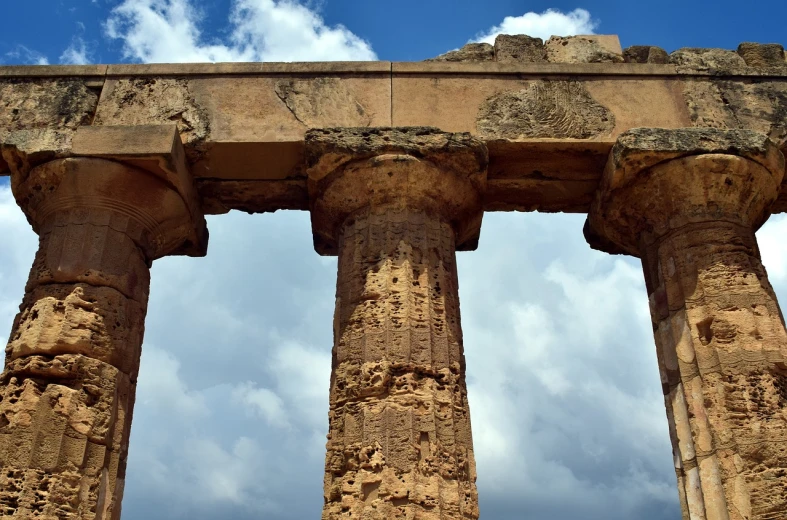 a close up of a stone structure with a sky in the background, inspired by Antonín Chittussi, shutterstock, agrigento, tall columns, stock photo, trinity