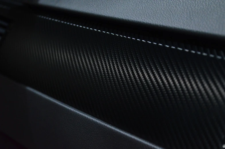 a close up of the interior of a car, a picture, carbon fibers, highly detailed product photo, matte detailed photo, high details photo