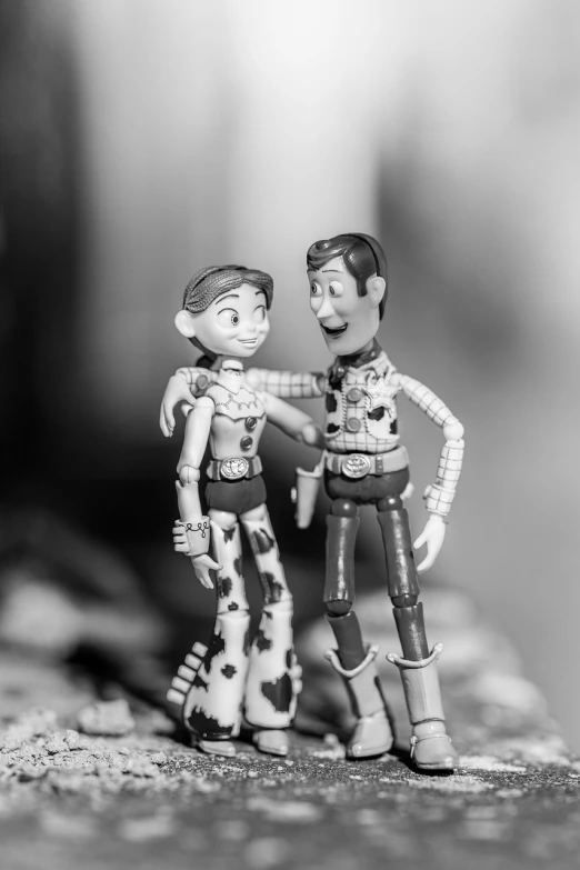 a couple of toy figures standing next to each other, a black and white photo, pexels, figuration libre, in style of disney pixar, happy couple, cowboys, closeup!!!!!!