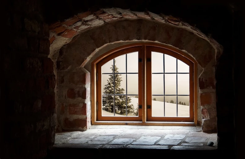 a window with a christmas tree outside of it, a picture, by Franz Hegi, pexels, romanticism, interior of a hobbit hole, brick, snow landscape, vista