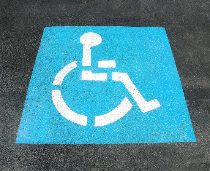 a handicap sign painted on the ground in a parking lot, by David Burton-Richardson, pixabay, street art, ffffound, light-blue steel-plate, wonderful masterpiece, perfect shading