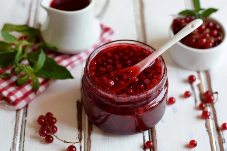 a jar of jam sitting on top of a table, a picture, shutterstock, crimson themed, slush)), ekaterina, refreshing colour