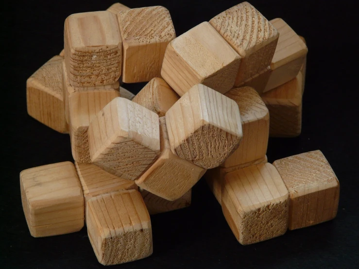 a pile of wooden blocks sitting on top of a table, a jigsaw puzzle, inspired by Isamu Noguchi, flickr, dodecahedron, close up front view, pine wood, 1 7 0 0 s