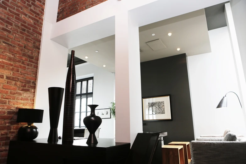 a black vase sitting on top of a table in a living room, by John Murdoch, flickr, high ceilings, big mirrors, interior of a loft, modern high sharpness photo