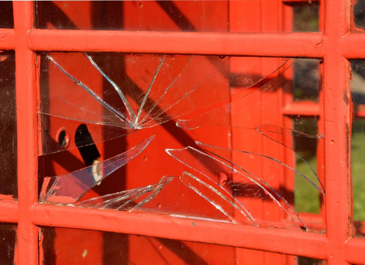 a broken glass window in a red phone booth, by Richard Carline, shutterstock, plein air, letterbox, postman pat, red grid, breakdown