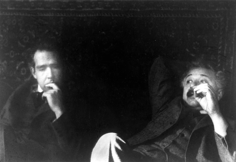 a couple of men sitting next to each other, by Germaine Krull, eraserhead, mark twain, resting, cinema still