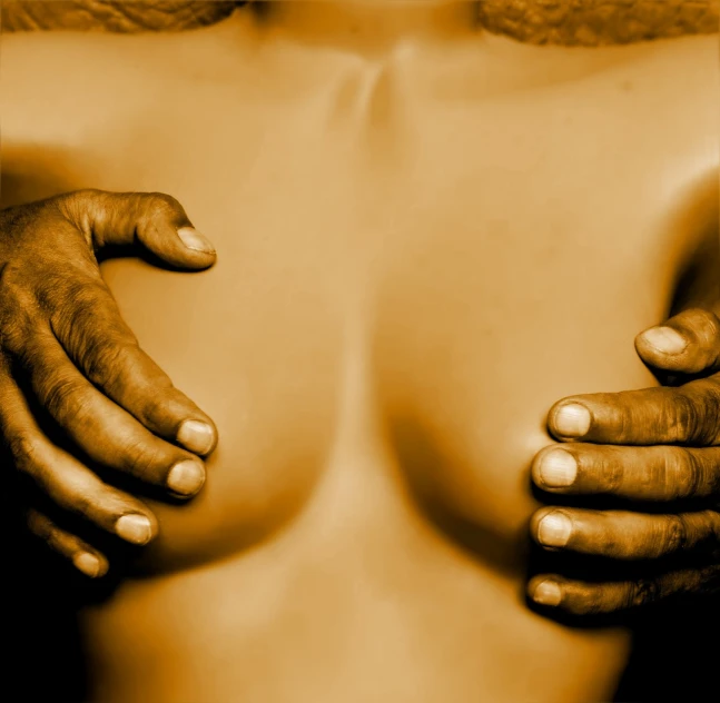 a close up of two hands on a woman's chest, a stock photo, by Alexander Mann, sepia, african, band of gold round his breasts, implants