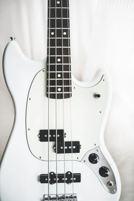 a close up of a white electric bass guitar, by Matija Jama, smooth!]