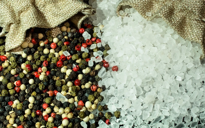 a pile of salt sitting on top of a table, a portrait, by György Rózsahegyi, pexels, renaissance, pepper, seafood in preserved in ice, hemp, red and white and black colors