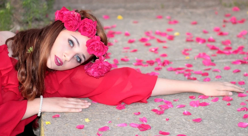 a woman laying on the ground with flowers in her hair, by Edward Corbett, pixabay contest winner, pink and red color style, gorgeous kacey rohl, portal made of roses, joey king