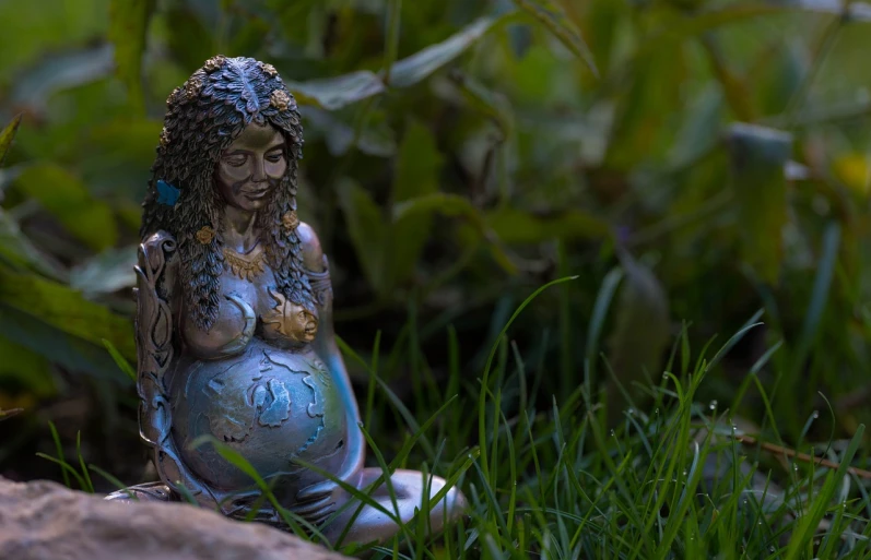 a statue of a woman sitting in the grass, a statue, inspired by Josephine Wall, featured on zbrush central, figuration libre, pregnant, embedded with gemstones, studio shot, at the waterside